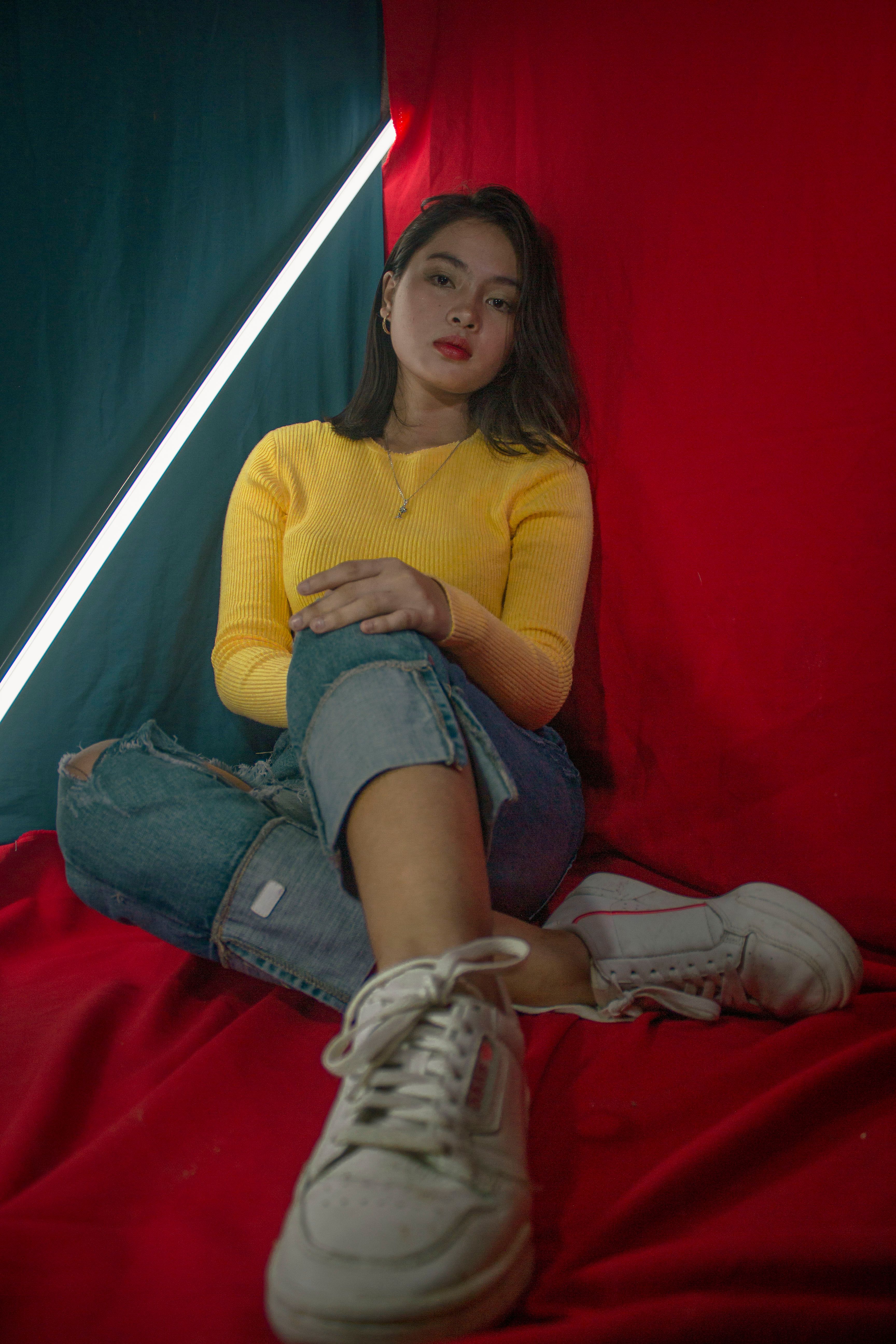 Woman in Yellow Long Sleeve Shirt and Blue Denim Jeans Posing ...