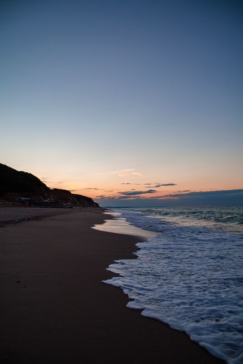 Free Serene beach view at sunset in Ormanlı, İstanbul, capturing peaceful waves and a colorful sky. Stock Photo