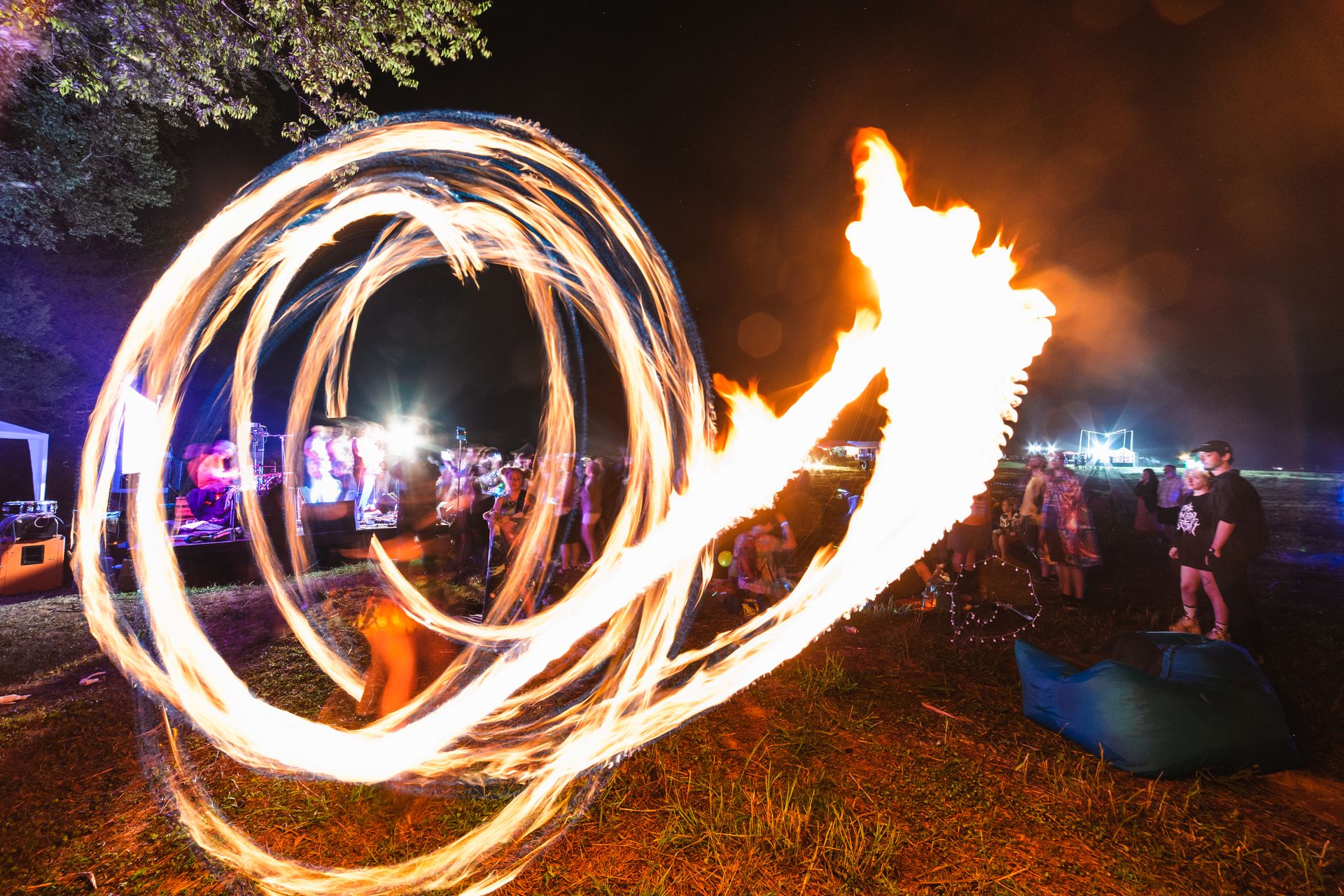 Vibrant long exposure capture of fire dancers performing at a night festival in Chattanooga, Tennessee.
