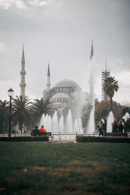 Captivating scene of the Blue Mosque behind flowing fountains in Istanbul, Turkey.