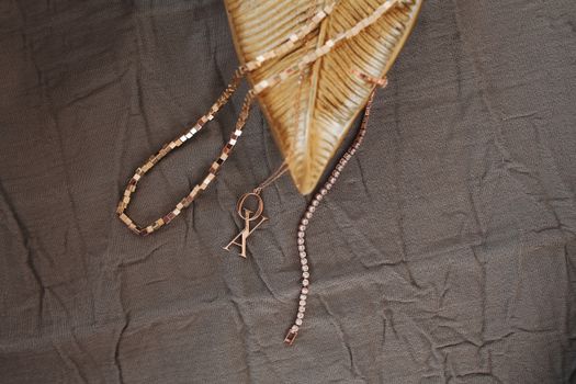 Glamorous gold jewelry displayed on creased fabric, highlighting luxury design.