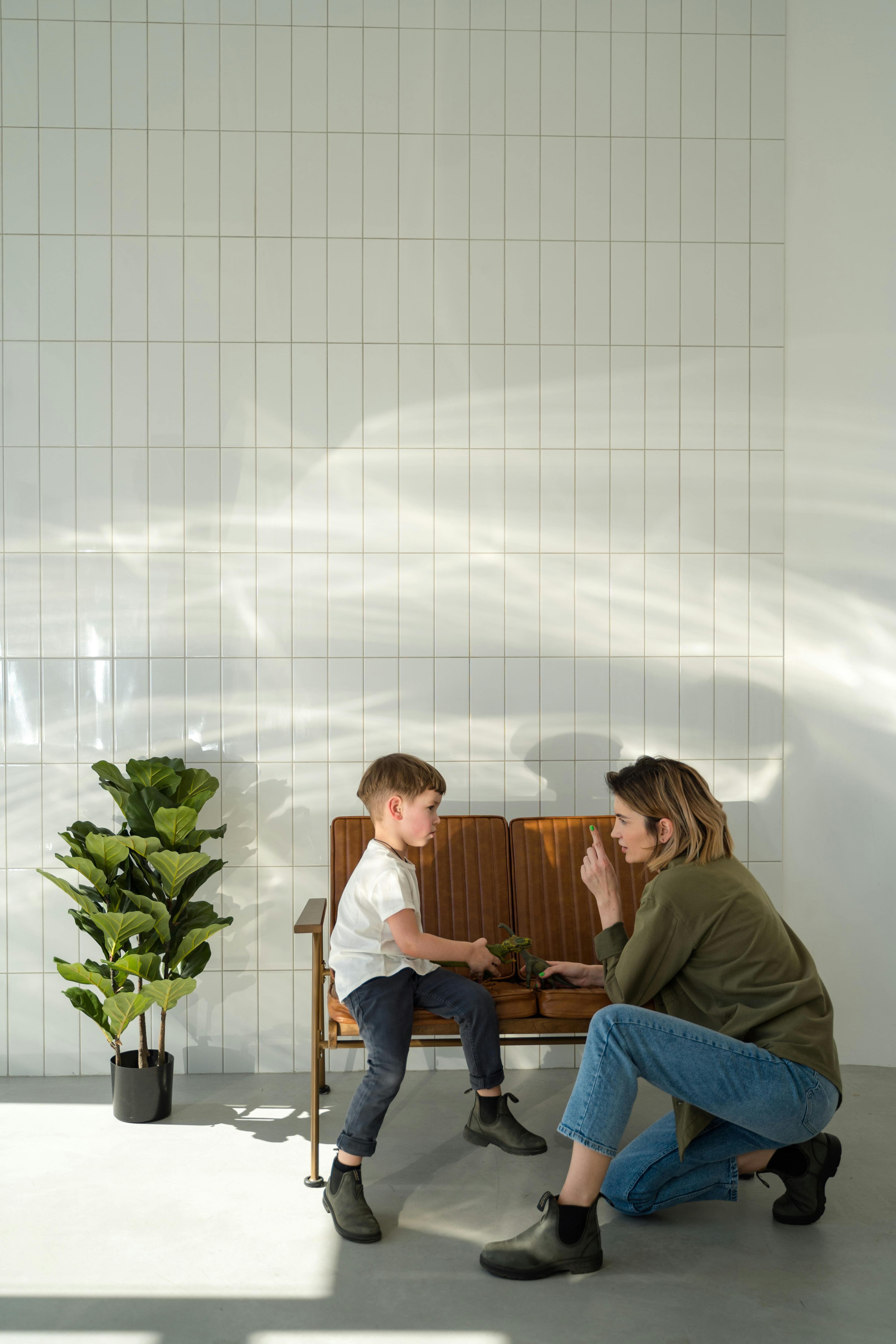 a woman playing with her son on a bench