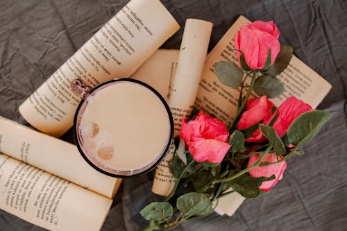 A Cup of Coffee with Book Pages and Flowers