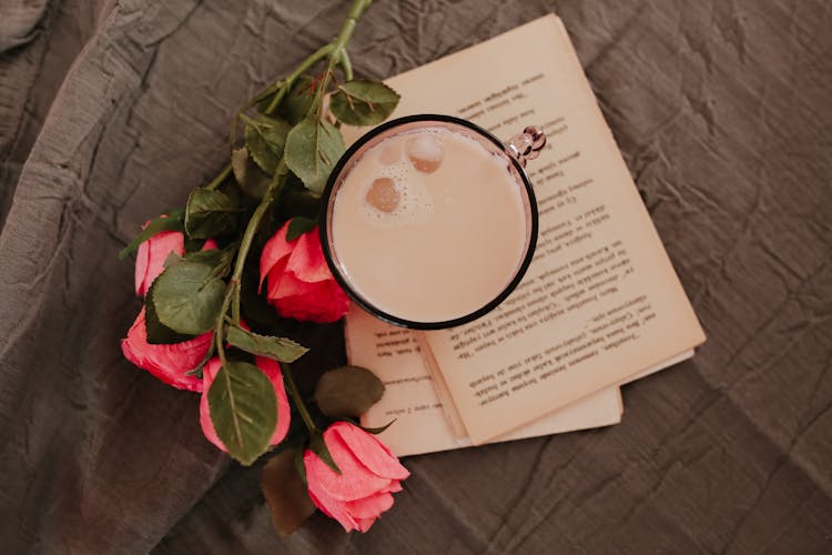 A Cup Of Coffee On Book Pages