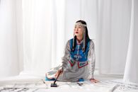 Woman in Gray and Blue Hoodie Sitting on White Table