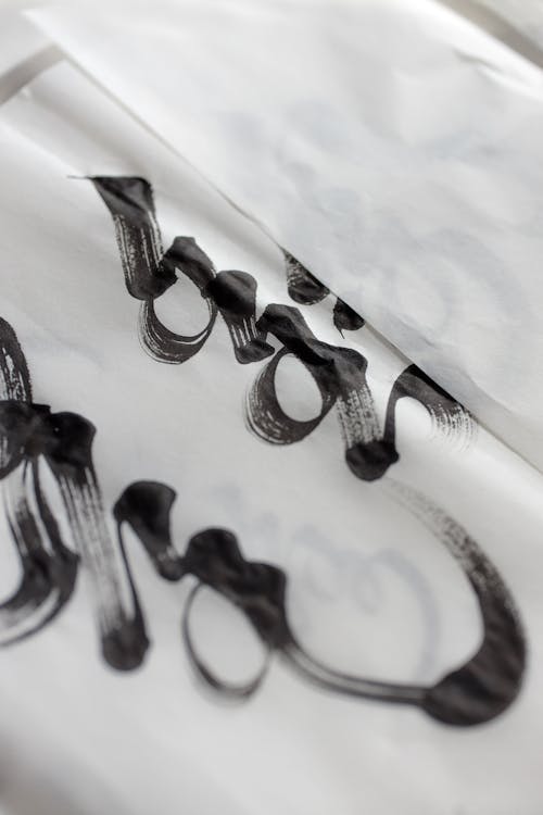 Close-Up Shot of Calligraphy on White Paper