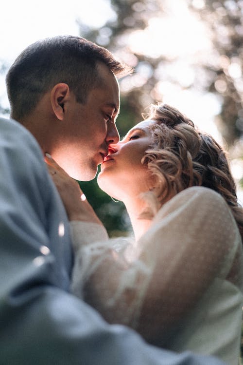 Low-Angle Shot of a Romantic Couple Kissing Each Other