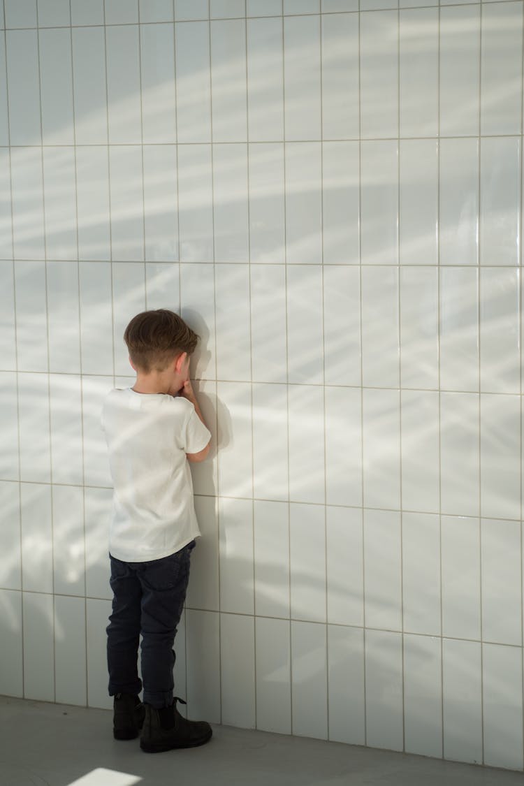 Boy Facing The Wall