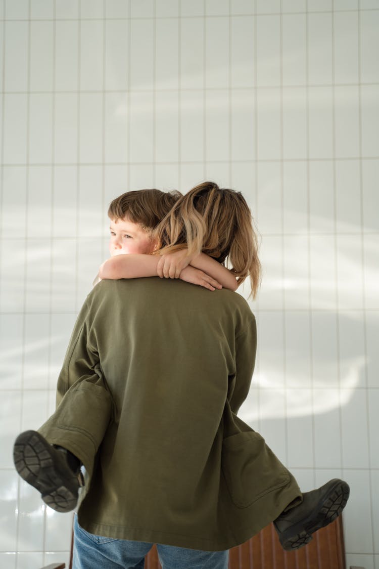 A Woman Carrying Her Son 