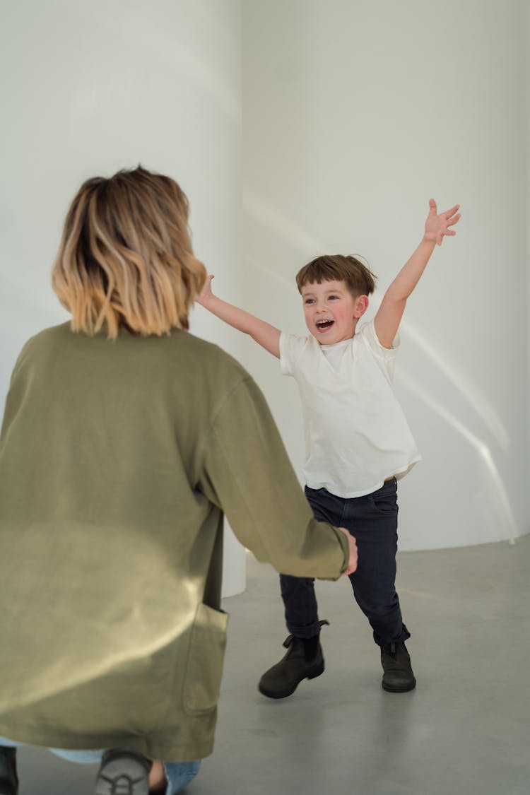 Happy Boy Running With Arms Outstretched