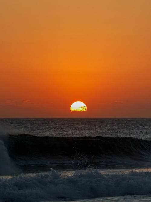 Ocean Waves Crashing on Shore during Sunset