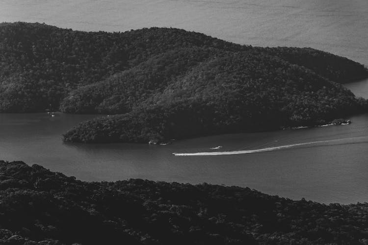 Grayscale Photo Of An Island On Body Of Water