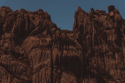 Stunning view of towering red sandstone cliffs against a clear blue sky.