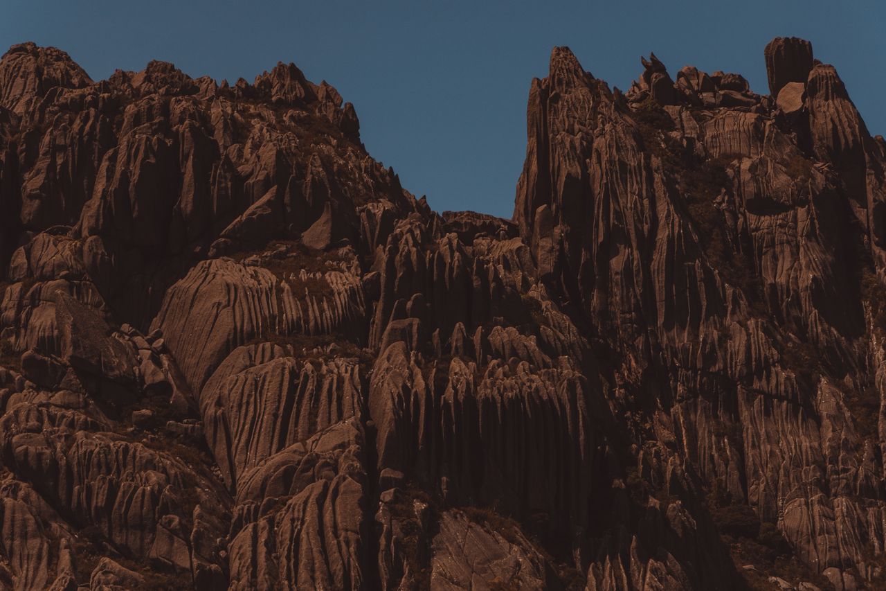 stunning view of towering red sandstone cliffs against a clear blue sk
