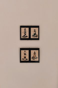 Four framed lighthouse prints on a neutral wall, perfect for decor inspiration.