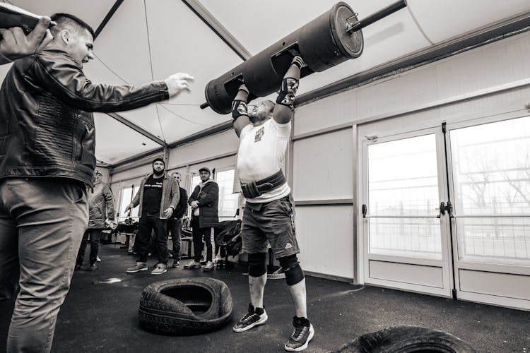 Man Weightlifting And His Friends Cheering Him 