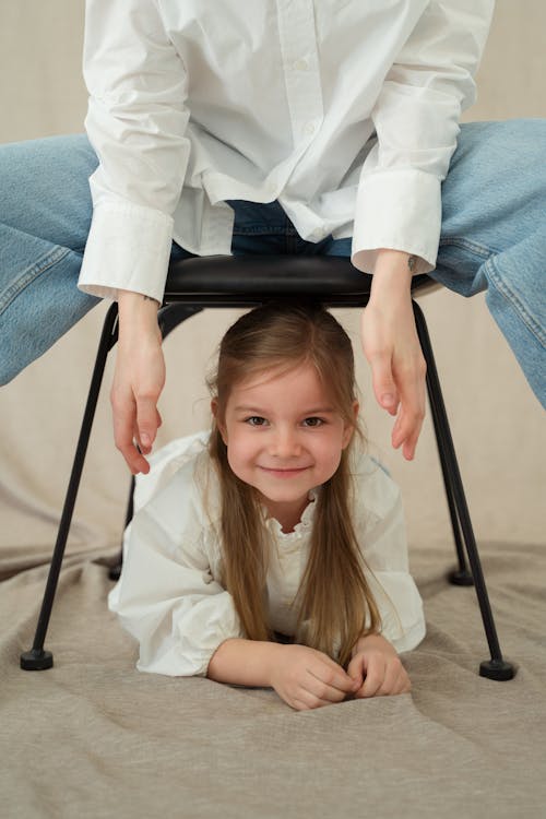 Photo of a Girl Under a Black Chair