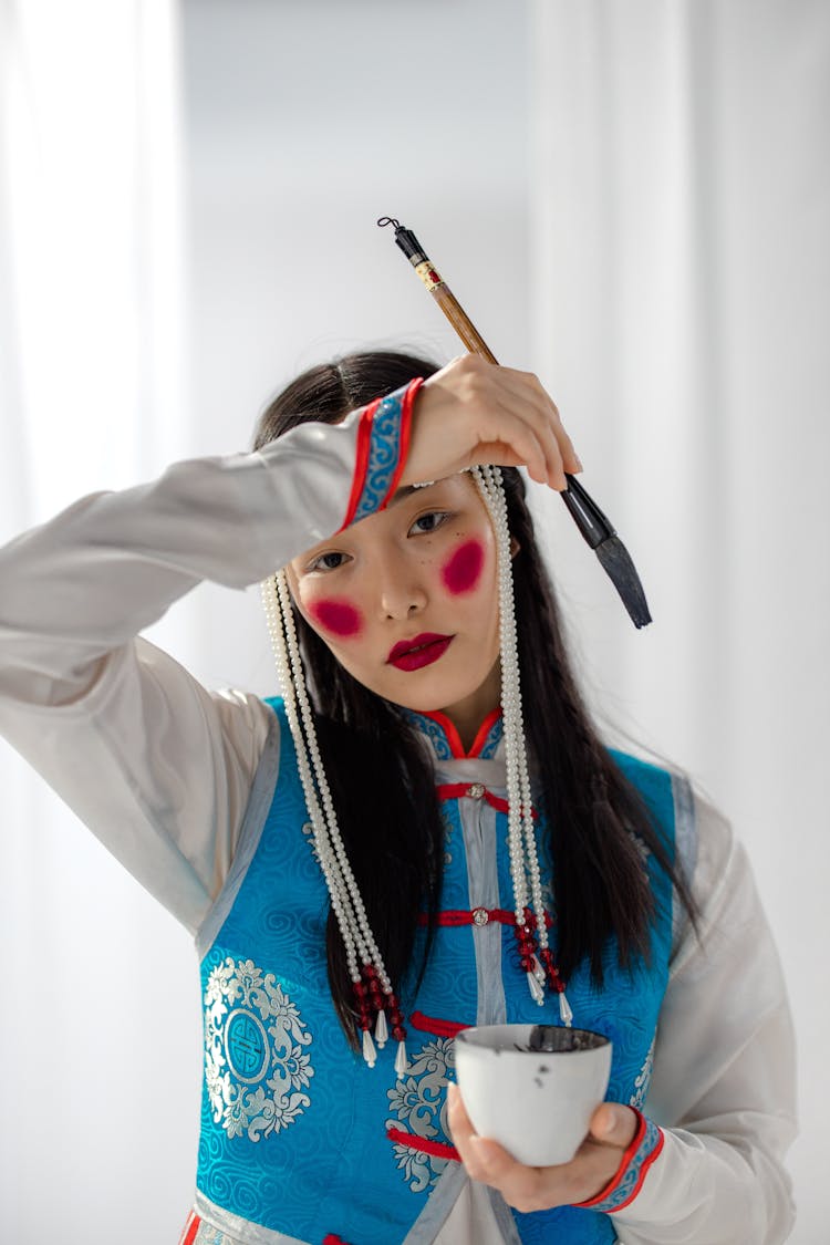 Asian Woman Holding A Brush