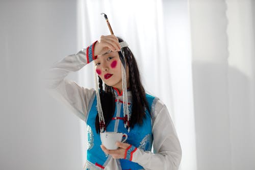 Buryat Woman in Traditional Dress Holding Cup in Hand