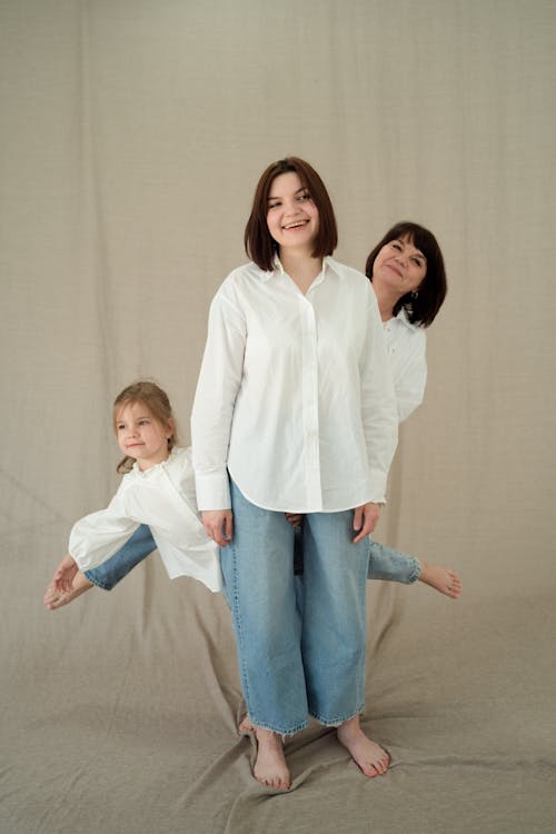 Women and a Girl Wearing White Long Sleeve Shirts