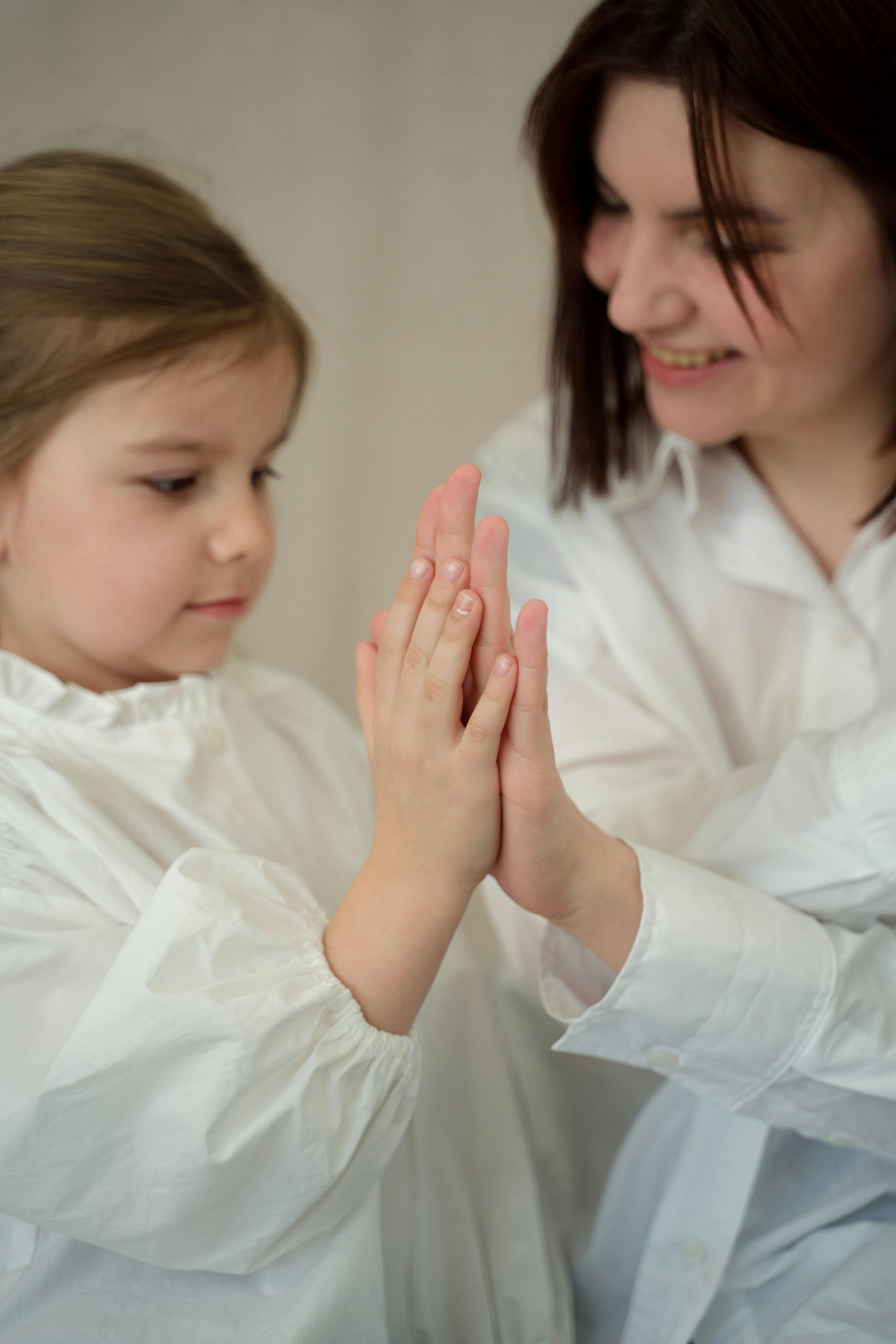 a woman and a young give doing a high five