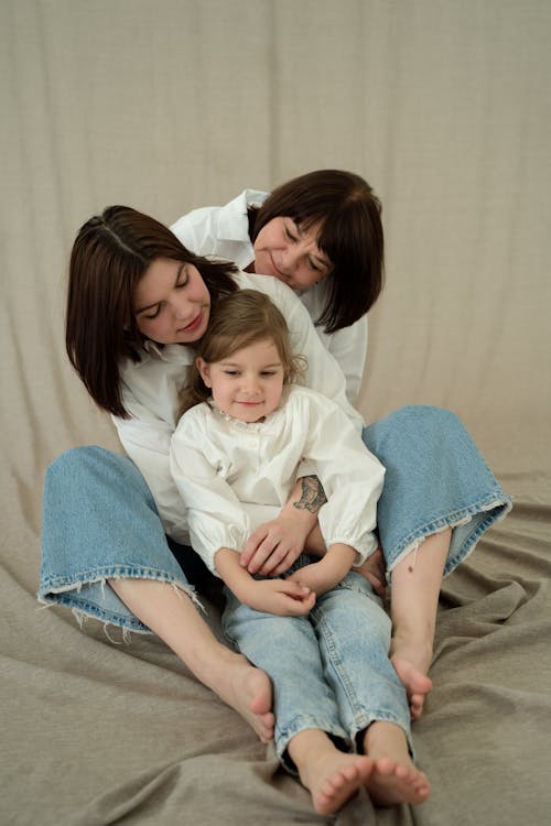 Photo of a Family Sitting on the Floor