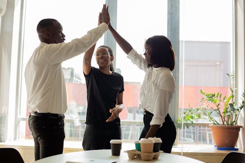 Free Workmates doing a High Five Stock Photo