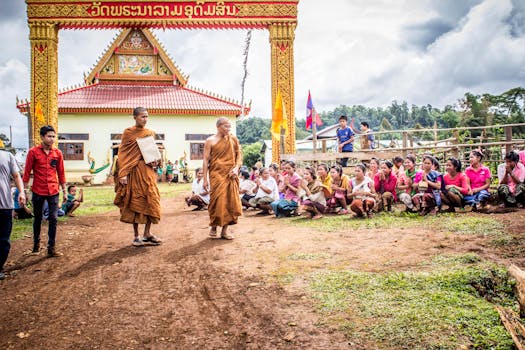Buddhist monks and villagers at a temple ceremony, showcasing cultural traditions.