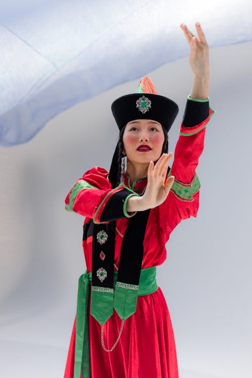 Beautiful Brunette Woman in Traditional Mongolian Dress and Hat