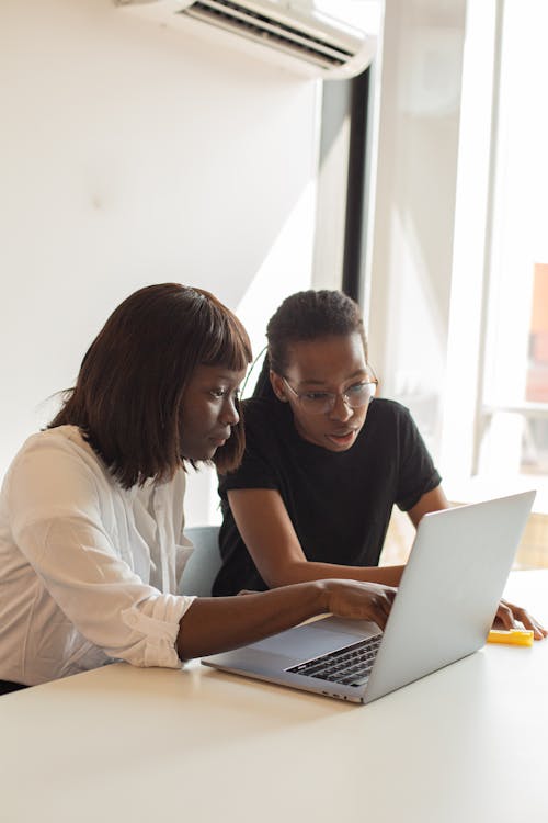 Female Colleagues looking at Laptop 