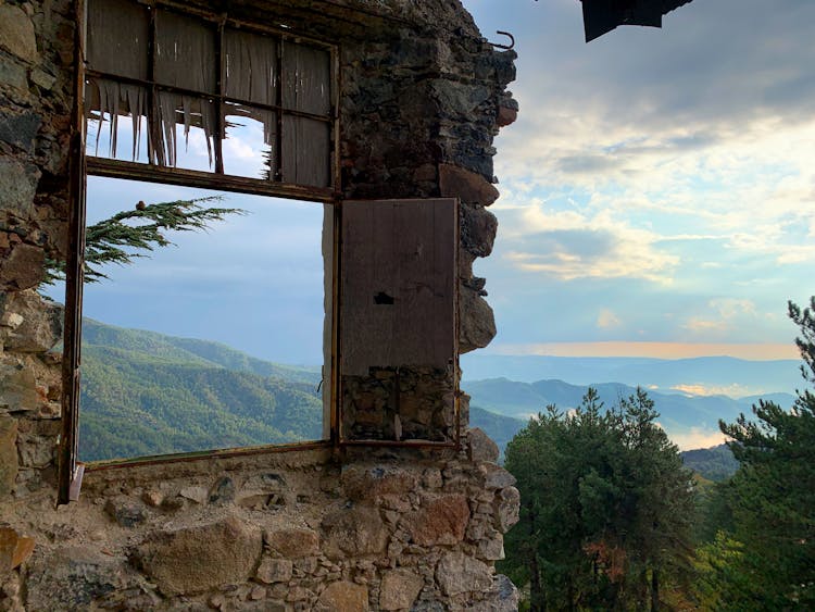 Stone Wall With Window In Mountain Landscape