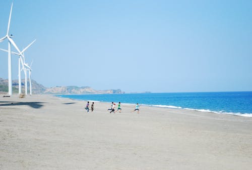 Kids Running on the Shore of a Beach