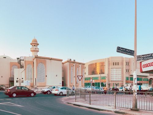 Free A lively street corner in Doha, Qatar, showcasing local architecture and bustling activity. Stock Photo