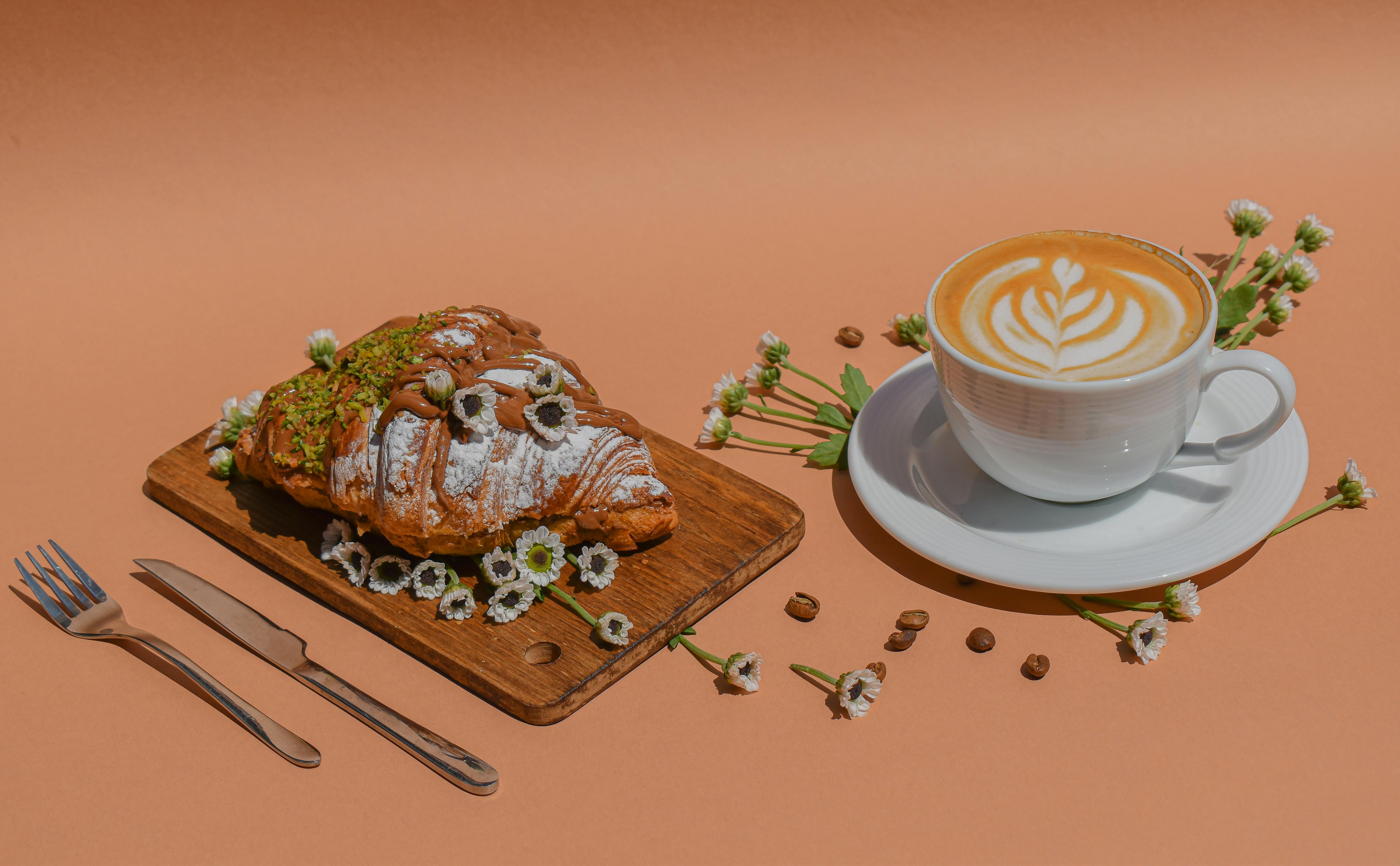 white ceramic cup on brown wooden chopping board