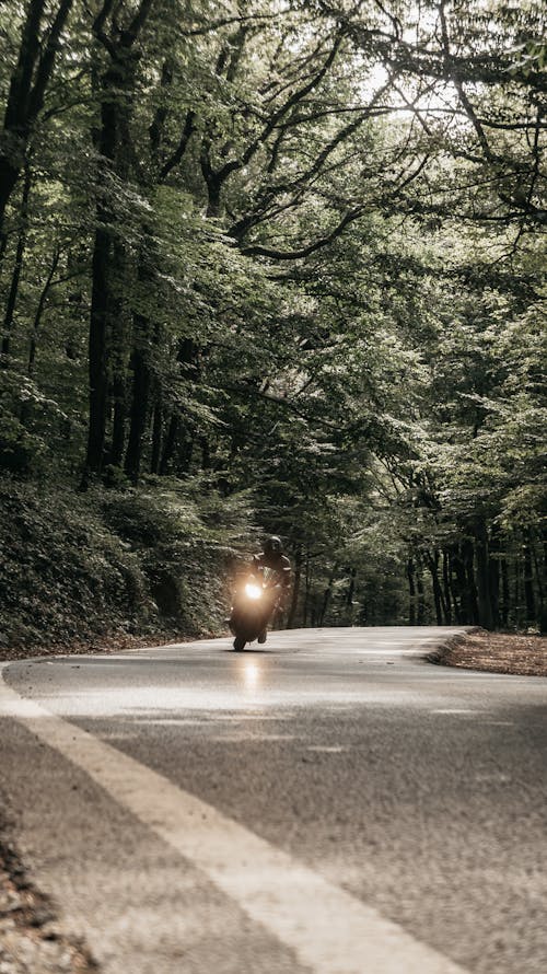 Man in a Motorcycle Driving Down the Road