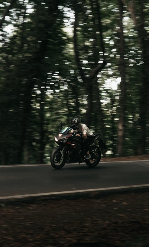 A Man Riding a Motorcycle on the Road