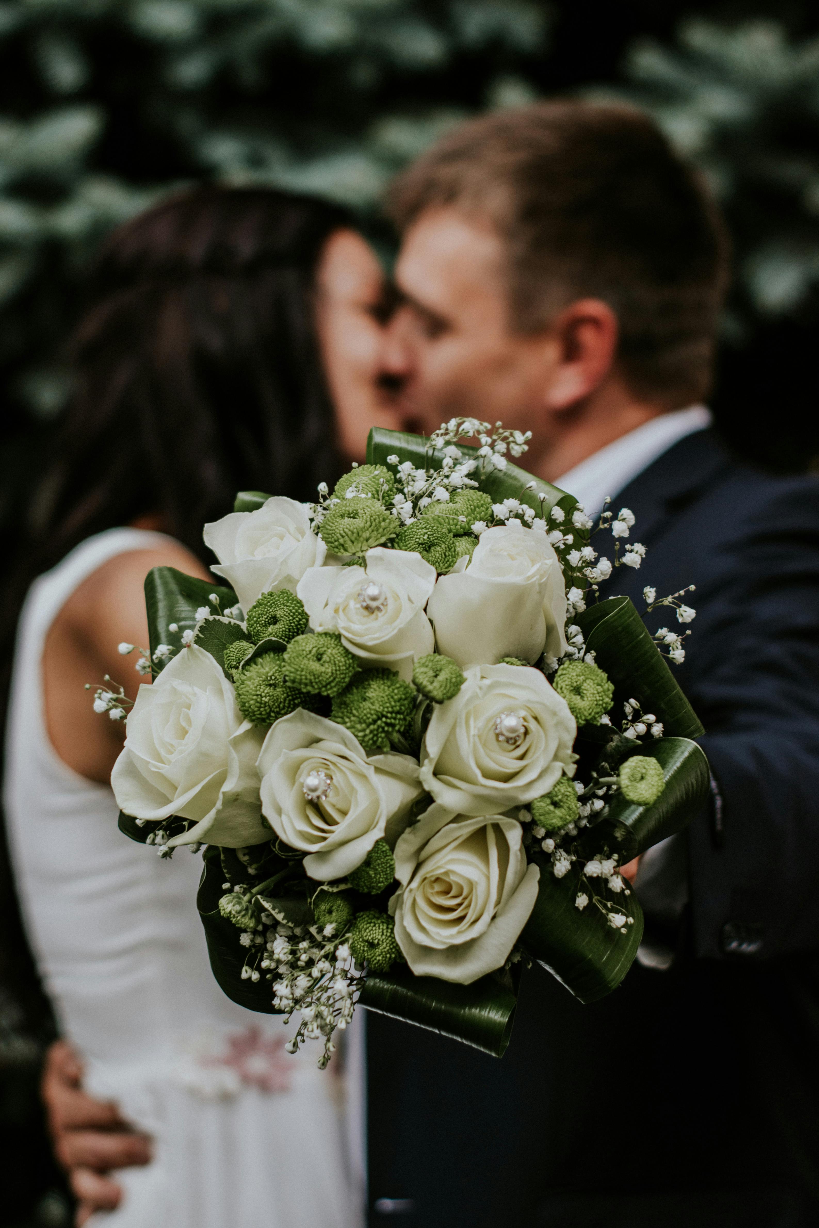 Groom and bride kissing on their wedding day.