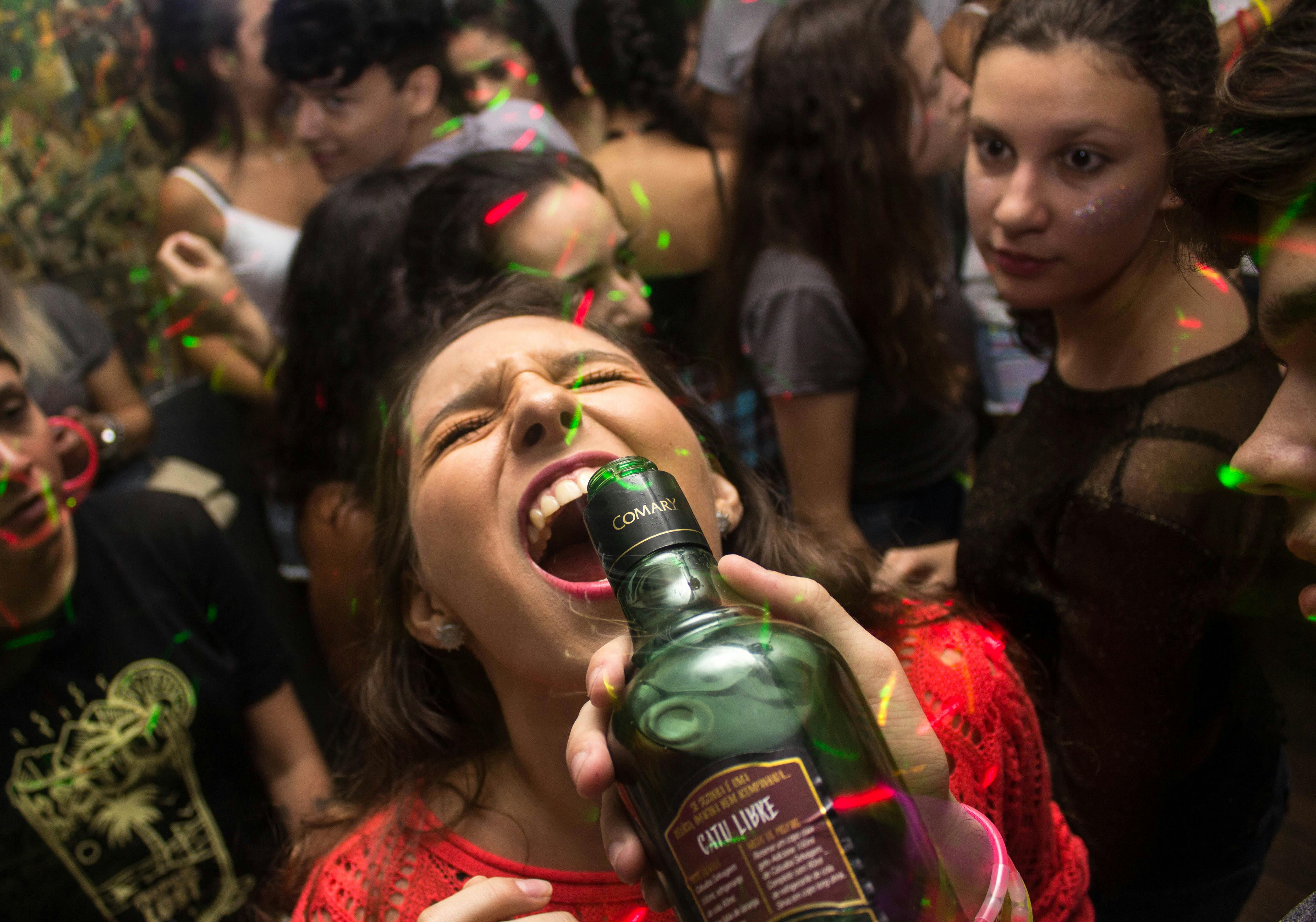 Woman drinking in a night club. | Photo: Pexels