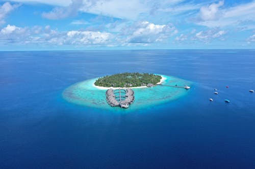 Free Drone Shot of a Private Island in the Middle of the Sea Stock Photo
