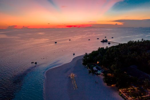 Breathtaking aerial view of Gaafu Dhaalu Atoll beach at sunset, highlighting the tropical beauty of the Maldives.