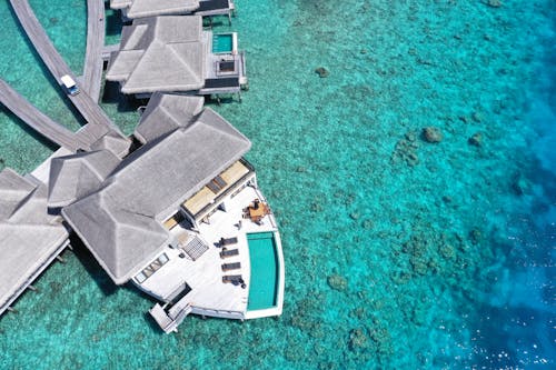 Aerial Photography of a Beautiful Villa Near Blue Water of the Sea