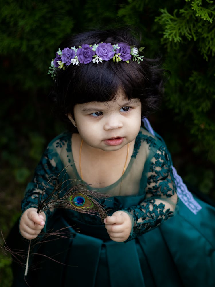 Girl Holding A Feather