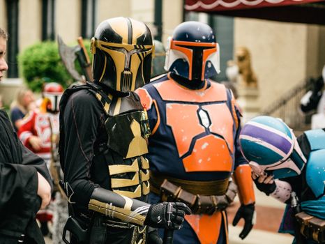Colorful Star Wars cosplay event in Joliet, featuring detailed Mandalorian costumes and helmets.