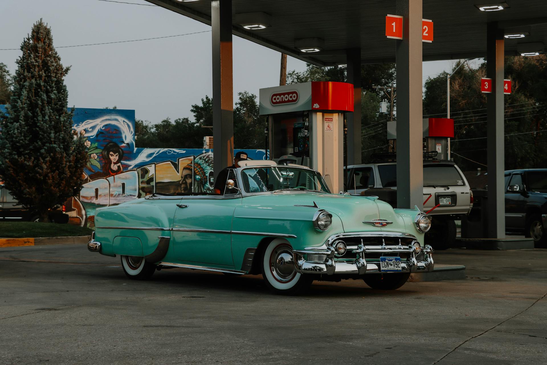 Classic vintage convertible parked at a Conoco gas station in Colorado Springs.