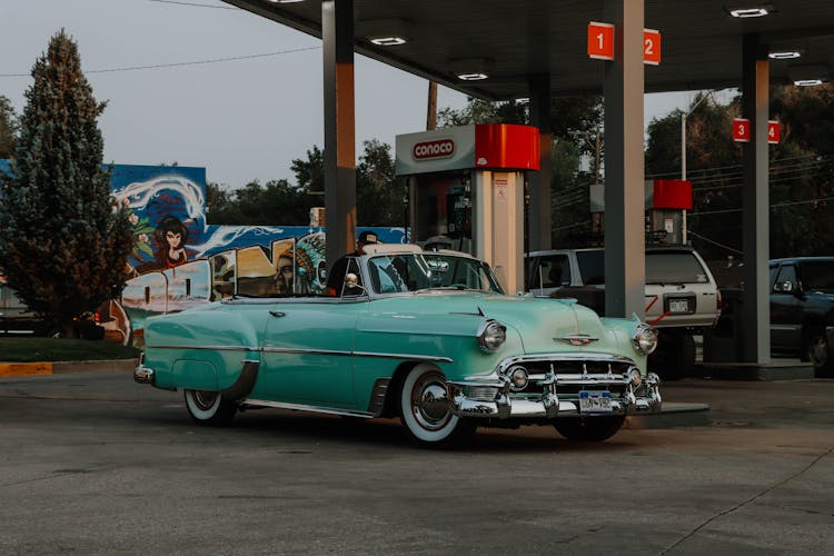 Teal Vintage Car Parked On Gas Station