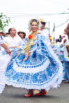 Festive dancers in vibrant traditional attire at a Panamanian parade celebration outdoors.