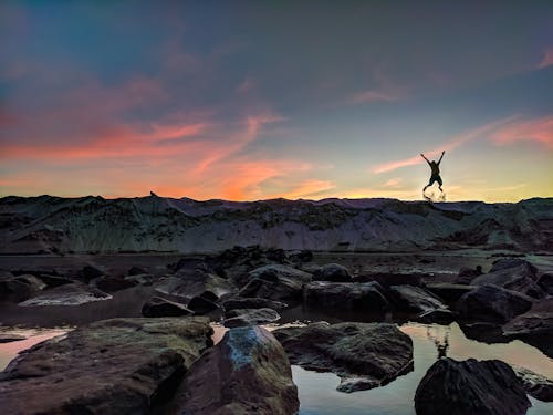 Free Person Jumping on Mountain Photo Stock Photo