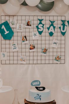 Charming first birthday setup with cake, photos, and festive decor.