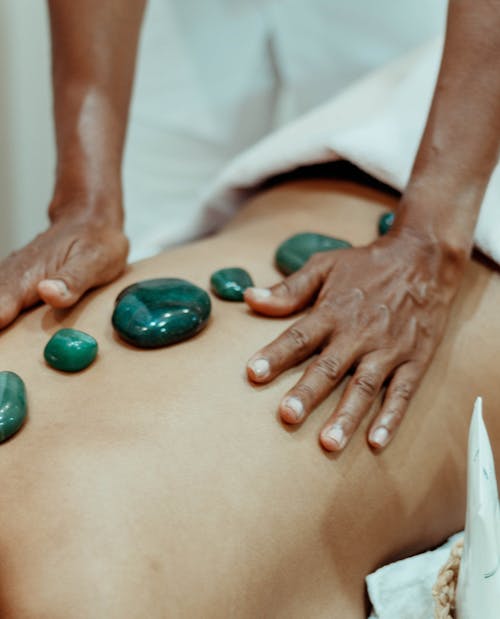 A Masseuse Massaging Client's Back