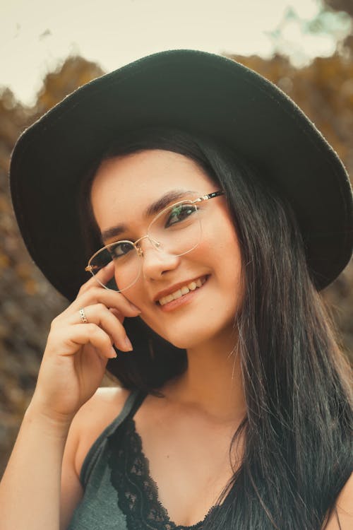 Smiling Woman in Black Hat and Eyeglasses